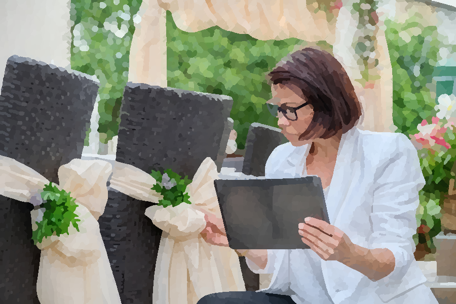 Wedding event planner coordinating ceremony details with a tablet