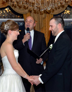 A couple smiling during their wedding ceremony